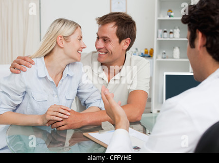 Happy couple just got good news from their doctor Stock Photo