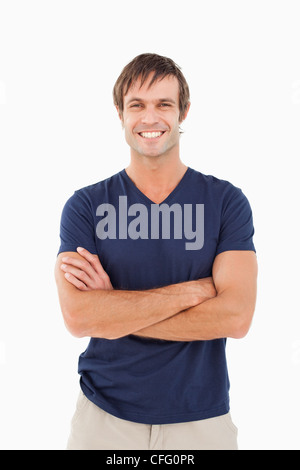 Smiling man standing up with arms crossed while looking at the camera Stock Photo