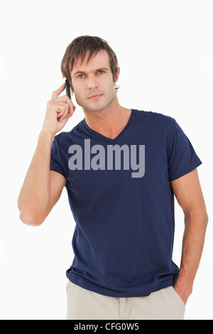 Serious man talking on the phone while looking at the camera Stock Photo