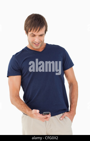 Surprised man receiving a text on his mobile phone Stock Photo