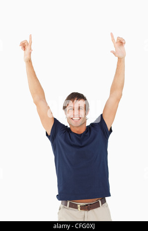 Excited Brunette Man Pointing Fingers Aside And Smiling Isolated Over 