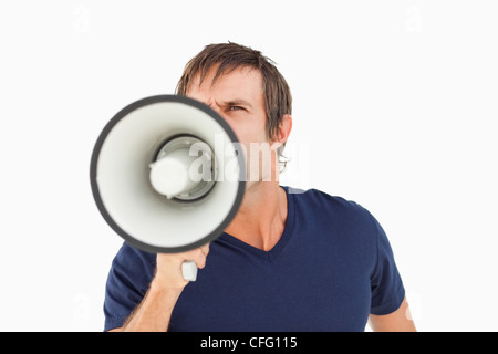 Furious man holding a megaphone while standing up Stock Photo