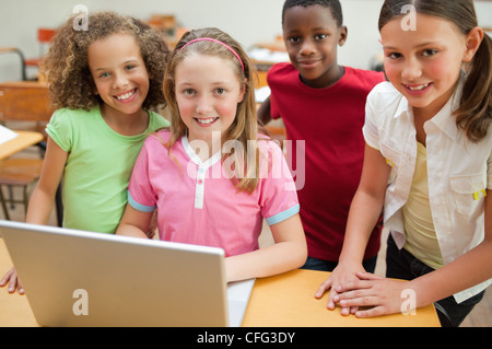 Smiling students using laptop Stock Photo