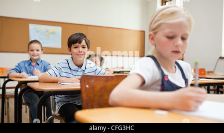 Three female students sitting in library and smiling Stock Photo - Alamy