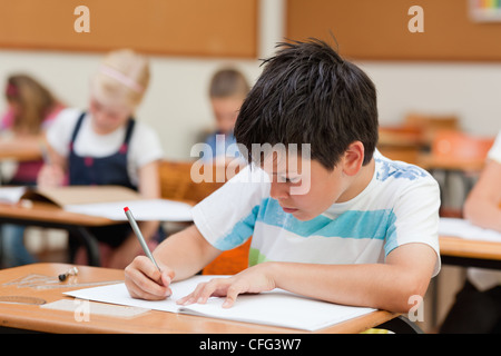 Primary student focused on exercise book Stock Photo