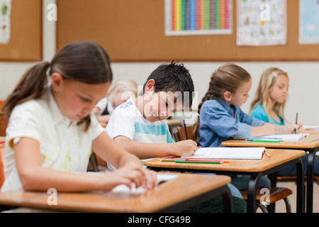 Side view of students doing their exercises Stock Photo