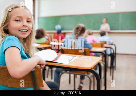 Smiling student turning around during class Stock Photo