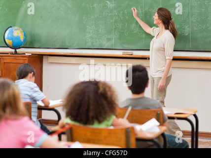 Teacher giving math lesson Stock Photo