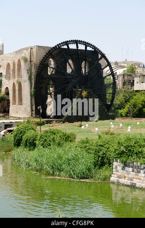 Hama. Syria. View of an enormous wooden water wheel on the banks of the Orontes River. There are seventeen wooden waterwheels Stock Photo