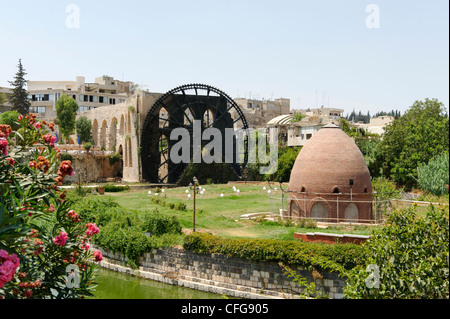 Hama. Syria. View of an enormous wooden water wheel on the banks of the Orontes River. There are seventeen wooden waterwheels Stock Photo