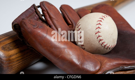 An antique baseball bat, mitt and ball on a white background Stock Photo