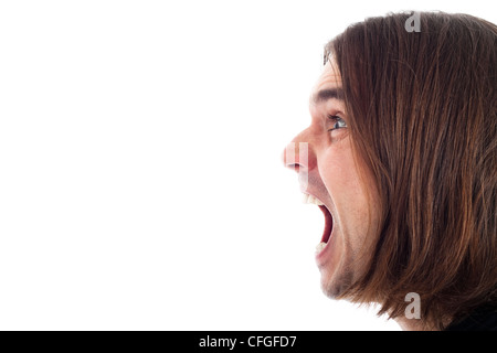 Profile of young long haired man face shouting, isolated on white background with large copy space. Stock Photo