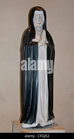 The 16th century French Renaissance white marble and black touchstone statue of a praying nun on display at the Louvre Museum in Paris, France. Stock Photo