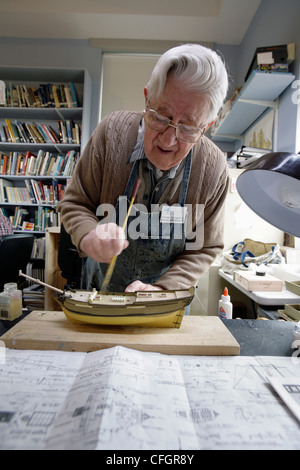 A man working on a sailing ship model Stock Photo