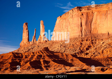 Sunrise over the Three Sisters, Monument Valley, Arizona USA Stock Photo