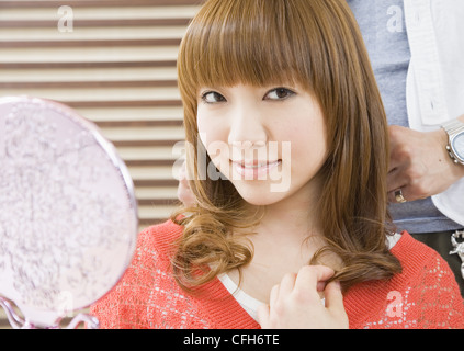 Young woman getting hair set Stock Photo