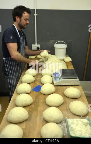 An artisan baker producing bread and buns Stock Photo - Alamy