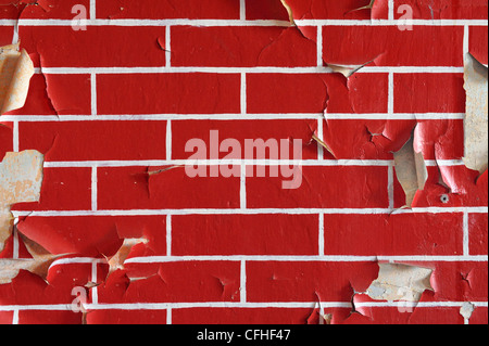 Old wall painted in a brick pattern with flaky paint Stock Photo