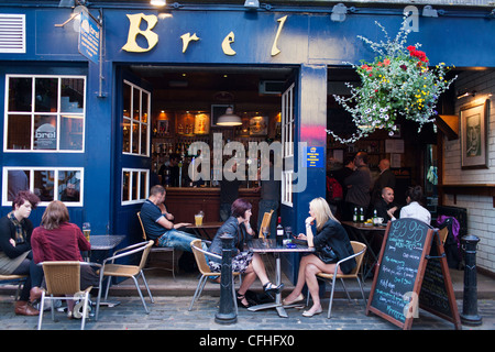 Customers and patrons sit outside of the bar Brel in the West End of Glasgows Byers road, a popular place to out at night. Stock Photo