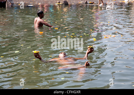 Man bathing in the sacred waters of the Godavari river. Ram Kund. Nasik. India Stock Photo
