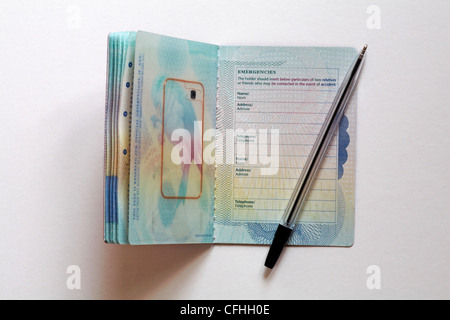 getting ready to fill in complete Emergencies details in new UK passport isolated on white background Stock Photo