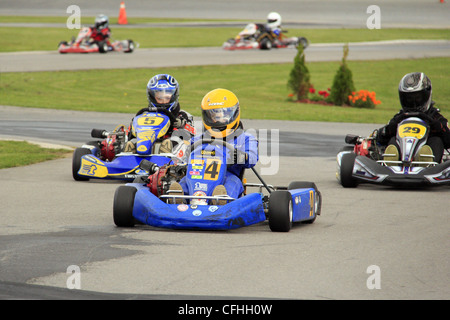 Children competing in a go kart race Stock Photo