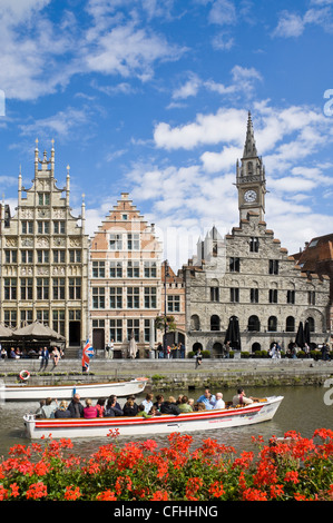 Vertical view of Gothic architecture on Graslei, Het Spijker (Grain Store house) with a tourist boat on the river Leie in Ghent, Belgium Stock Photo