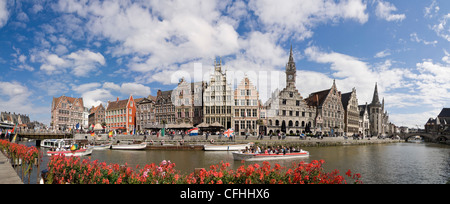 Horizontal (2 picture stitch) view of Graslei, Tussen Bruggen, with boat trips sailing passed on the river Leie in Ghent, Belgium Stock Photo