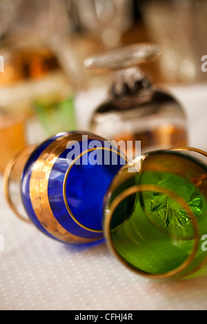 Hand blown etched crystal brandy snifters in blue and green with gold leaf Stock Photo
