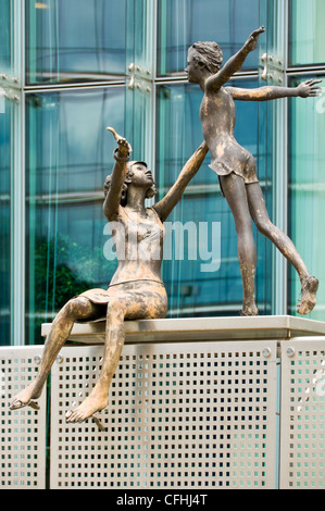 Vertical close up of life like bronze sculptures of a woman and child outside the Charlemagne Building in central Brussels. Stock Photo