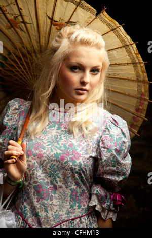 Blond girl in period dress with brolly Stock Photo