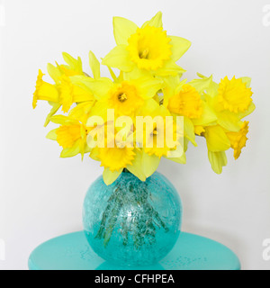 Beautiful bunch of fresh spring daffodils in a glass vase Stock Photo