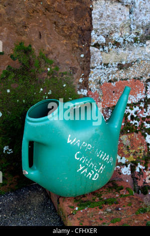 Churchyard watering can Stock Photo