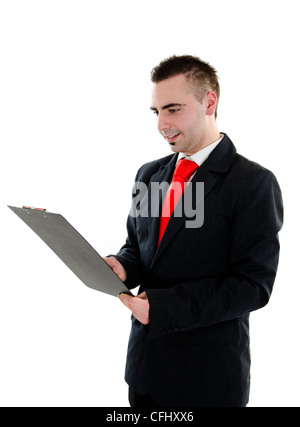 Young businessman holding and writing in black office clipboard - isolated on white background Stock Photo