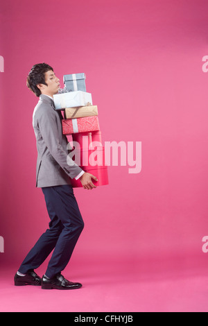 A man holding the many gift boxes Stock Photo