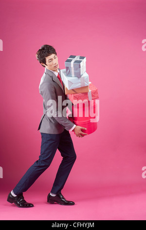 A man holding the many gift boxes Stock Photo