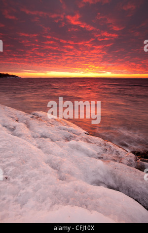 Icy coastline and colorful skies at dusk at Larkollen in Rygge, Østfold fylke, Norway. Stock Photo