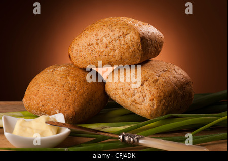 Wholemeal bread rolls on brown background. Stock Photo