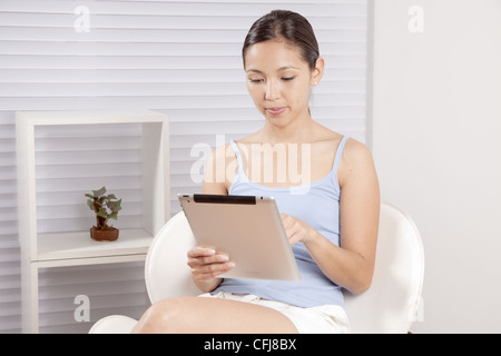 Young woman using tablet PC Stock Photo