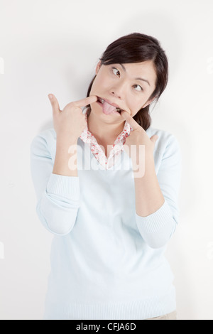 Young woman making funny face Stock Photo
