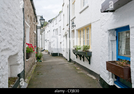 Narrow winding street in fishing village of Polperro, Cornwall UK Stock Photo
