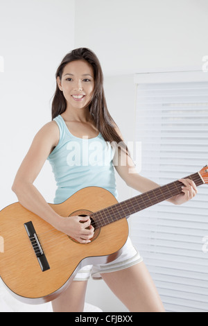 Young woman playing the guitar Stock Photo - Alamy