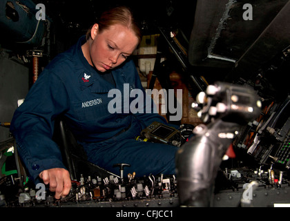 ATLANTIC OCEAN (March 13, 2012) Aviation Technician 2nd Class Bethany A. Anderson assigned to the Arleigh Burke-class guided-missile destroyer USS James E. Williams (DDG 95) performs maintenance on an SH-60B Sea Hawk helicopter. James E. Williams is deployed as part of the Enterprise Carrier Strike Group to support maritime security operations and theater security cooperation efforts in the U.S. 5th and 6th Fleet areas of responsibility. Stock Photo