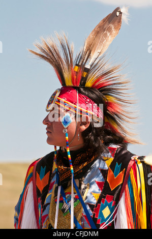 Traditional Native American youth, of the Blackfeet Nation, makes an offering of plant medicine