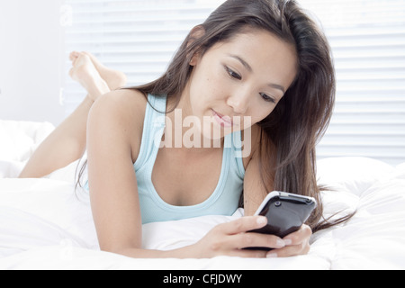 Young woman using cell phone Stock Photo