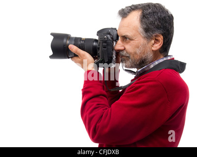 Portrait of mature man taking photos with DSLR camera on white background Stock Photo