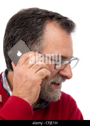 Middle-aged man talking on iPhone isolated on white background Stock Photo