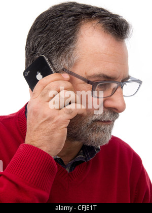 Middle-aged man talking on iPhone isolated on white background Stock Photo