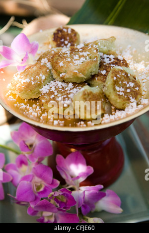 Thai coconut cookies dusted with powder sugar served in a traditional setting Stock Photo