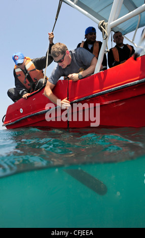 Navy Diver 2nd Class Tyler Smith, assigned to Mobile Diving and Salvage Unit 2, Company 2-1, lowers a side scan sonar with the help of Colombian divers off the coast of Cartagena, Colombia. Company 2-1 is participating in Navy Dive Southern Partnership St Stock Photo